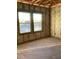 Unfinished bedroom featuring a concrete floor, bare walls, open ceiling, and two windows at 5724 Haystack Drive, St Cloud, FL 34771