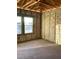 Unfinished bedroom featuring a concrete floor, bare walls, open ceiling, and two windows at 5724 Haystack Drive, St Cloud, FL 34771