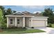 Charming single-story home featuring a two car garage, neutral paint, and a well manicured lawn at 5724 Haystack Drive, St Cloud, FL 34771