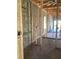 Unfinished hallway showcasing bare framing and concrete floor at 5724 Haystack Drive, St Cloud, FL 34771