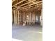 Unfinished interior showcasing bare framing, a concrete floor, and an open ceiling at 5724 Haystack Drive, St Cloud, FL 34771