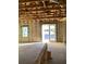 Unfinished living room featuring a concrete floor, bare walls, open ceiling, and sliding glass doors at 5724 Haystack Drive, St Cloud, FL 34771