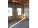 New construction room with concrete walls, wood trim and newly installed windows allowing for plenty of sunlight at 5724 Haystack Drive, St Cloud, FL 34771