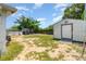Backyard with a shed, a pool area with a deck, and a partially fenced yard at 811 Casselberry Dr, Lake Wales, FL 33853