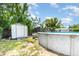 Backyard featuring a shed and an above-ground pool with a deck and pool equipment at 811 Casselberry Dr, Lake Wales, FL 33853