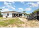 Backyard view featuring a house, pool with deck, and grassy area with a walkway at 811 Casselberry Dr, Lake Wales, FL 33853