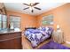 Comfortable bedroom with wood floors and plenty of natural light from two large windows at 811 Casselberry Dr, Lake Wales, FL 33853
