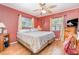 Bedroom with hardwood flooring, windows with blinds, and ceiling fan at 811 Casselberry Dr, Lake Wales, FL 33853