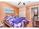 Bright bedroom with butterfly themed bedding, wood floors, and natural light at 811 Casselberry Dr, Lake Wales, FL 33853