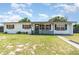 Charming single-story home featuring a cozy front porch and a well-maintained lawn at 811 Casselberry Dr, Lake Wales, FL 33853