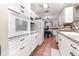 Spacious kitchen featuring white cabinetry and appliances with great natural light at 811 Casselberry Dr, Lake Wales, FL 33853