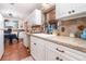 Bright kitchen with decorative backsplash, solid countertops, and stainless steel sink at 811 Casselberry Dr, Lake Wales, FL 33853