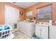 Laundry area featuring a utility sink, washer, and dryer next to a back door at 811 Casselberry Dr, Lake Wales, FL 33853