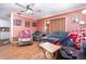Comfortable living room featuring hardwood floors, ample seating, and warm lighting at 811 Casselberry Dr, Lake Wales, FL 33853
