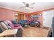 Cozy living room with hardwood floors, ceiling fan, and comfortable seating arrangement at 811 Casselberry Dr, Lake Wales, FL 33853
