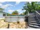 Pool deck with stairs leading to an above-ground pool, bordered by greenery at 811 Casselberry Dr, Lake Wales, FL 33853