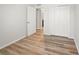 Bedroom with wood look floors, white walls and a large closet at 1183 Honey Blossom Dr, Orlando, FL 32824