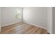 Bedroom with wood look floors, white walls, one window and a closet at 1183 Honey Blossom Dr, Orlando, FL 32824