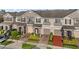 Townhome exteriors featuring neutral paint, private entrances and driveways with manicured landscaping at 1183 Honey Blossom Dr, Orlando, FL 32824
