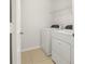 Bright laundry room features a washer, dryer, neutral walls, and a wire shelf for convenient storage at 1183 Honey Blossom Dr, Orlando, FL 32824