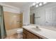 Bathroom with vanity, toilet, bathtub and shower featuring neutral design elements at 1440 12Th St, Clermont, FL 34711