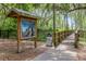 Entrance to the Palatlakaha Boardwalk with signage nestled among trees at 1440 12Th St, Clermont, FL 34711