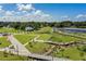 Beautiful aerial view of green community spaces, walkways, and water features under a sunny sky at 1440 12Th St, Clermont, FL 34711