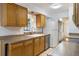 Bright kitchen featuring wooden cabinets, a white refrigerator, and a sink overlooking the dining area at 1440 12Th St, Clermont, FL 34711