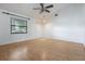 Inviting living room with wood floors, a ceiling fan, and a large window at 1440 12Th St, Clermont, FL 34711
