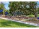 A local playground features multiple slides, climbing areas, and swings on a grassy play area at 1440 12Th St, Clermont, FL 34711