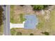 Bird's-eye view of home showcasing its roof, driveway and the surrounding expansive lot with mature trees and road access at 231 Marion Oaks Trl, Ocala, FL 34473