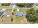 An aerial perspective of a one-story home with lush trees and a neat neighborhood surrounding the property at 231 Marion Oaks Trl, Ocala, FL 34473