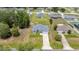An aerial view of a one-story home on a neatly kept lawn in a peaceful neighborhood at 231 Marion Oaks Trl, Ocala, FL 34473
