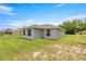 A lovely one-story home featuring a grassy backyard, with a simple backyard landscape at 231 Marion Oaks Trl, Ocala, FL 34473