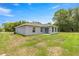 A charming one-story home featuring a grassy backyard, perfect for outdoor relaxation and recreation at 231 Marion Oaks Trl, Ocala, FL 34473