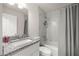 Bathroom features a shower-tub combination with marble-look surround, granite vanity, and modern toilet at 231 Marion Oaks Trl, Ocala, FL 34473