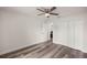 Bedroom features a closet, a ceiling fan, wood-look flooring, and a door leading into another room at 231 Marion Oaks Trl, Ocala, FL 34473