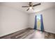Bedroom features a window with blue curtains, wood-look flooring and a ceiling fan at 231 Marion Oaks Trl, Ocala, FL 34473