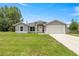 Charming single-story home with a well-maintained lawn and attached two-car garage at 231 Marion Oaks Trl, Ocala, FL 34473