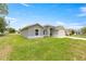 A charming one-story home showcasing lush green grass, and a driveway that leads to an attached garage at 231 Marion Oaks Trl, Ocala, FL 34473