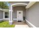 Inviting front entryway with arched doorway and a welcoming 'hello' doormat at 231 Marion Oaks Trl, Ocala, FL 34473