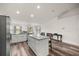 Kitchen island with granite countertop and barstool seating adjacent to stainless steel appliances at 231 Marion Oaks Trl, Ocala, FL 34473