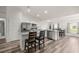 Bright, modern kitchen with white cabinets, a stainless steel fridge, and breakfast bar seating at 231 Marion Oaks Trl, Ocala, FL 34473