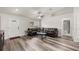 Living room with leather sofa, hardwood floors, and a view into the bathroom at 231 Marion Oaks Trl, Ocala, FL 34473