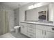 Modern bathroom with double vanity, granite countertops, and tiled shower with glass door at 231 Marion Oaks Trl, Ocala, FL 34473