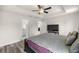 Main bedroom featuring a ceiling fan, wood-look flooring, and an ensuite bathroom at 231 Marion Oaks Trl, Ocala, FL 34473