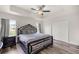Spacious main bedroom with tray ceiling, ceiling fan, a decorative headboard and wood-look floors at 231 Marion Oaks Trl, Ocala, FL 34473