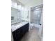 A bathroom featuring a granite countertop, a modern sink, and a glass-enclosed shower at 663 Jamaica Cir, Lakeland, FL 33803