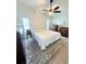 Comfortable bedroom featuring a ceiling fan, vintage dressers, and ample natural light at 663 Jamaica Cir, Lakeland, FL 33803