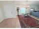 Bright dining area with vintage chandelier, table and chairs, rug, and view into entry at 663 Jamaica Cir, Lakeland, FL 33803
